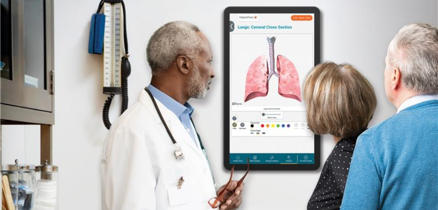 Patients and provider viewing exam room screen showing lung anatomy